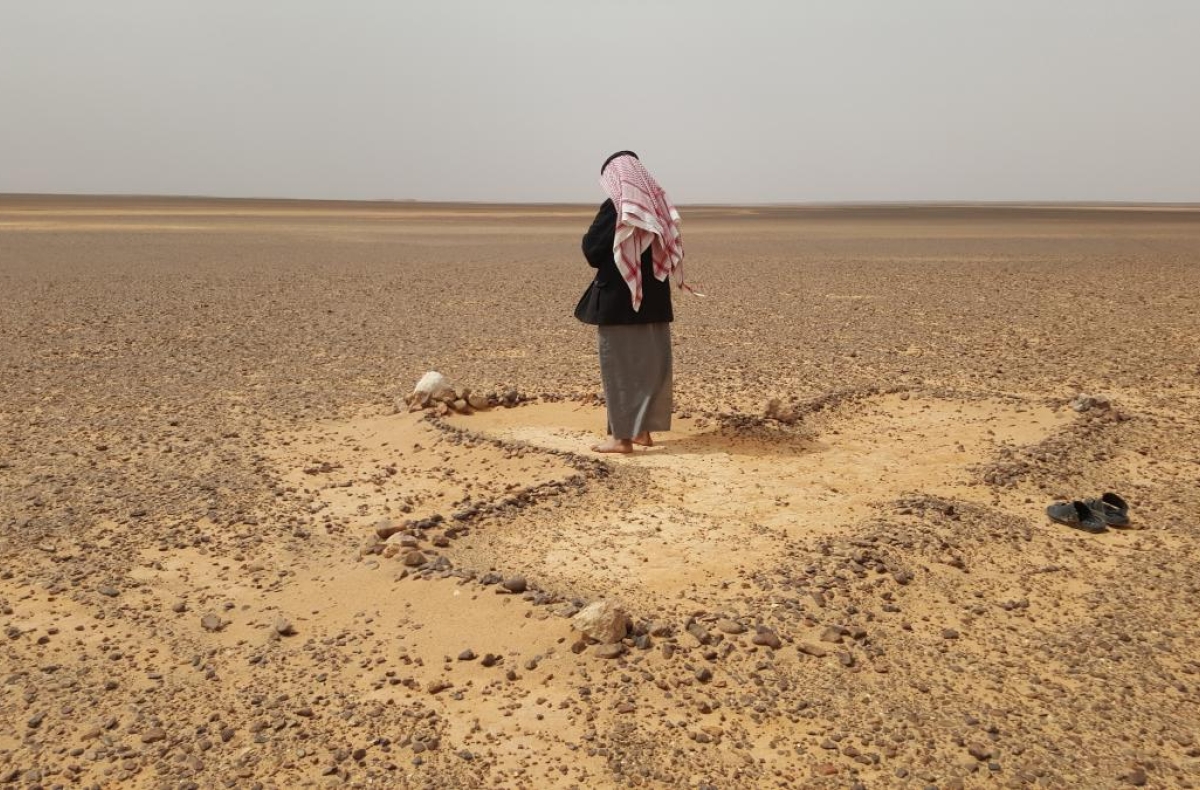 A Bedouin man prays in arid eastern Jordan.