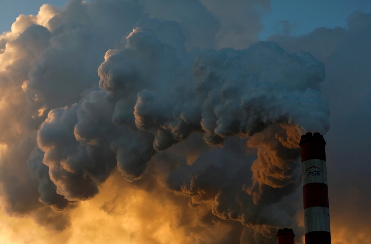 smoke rises from an industrial smokestack