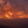 A wildfire rages on a distant hill in Arizona