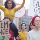 People marching with signs to support climate change action