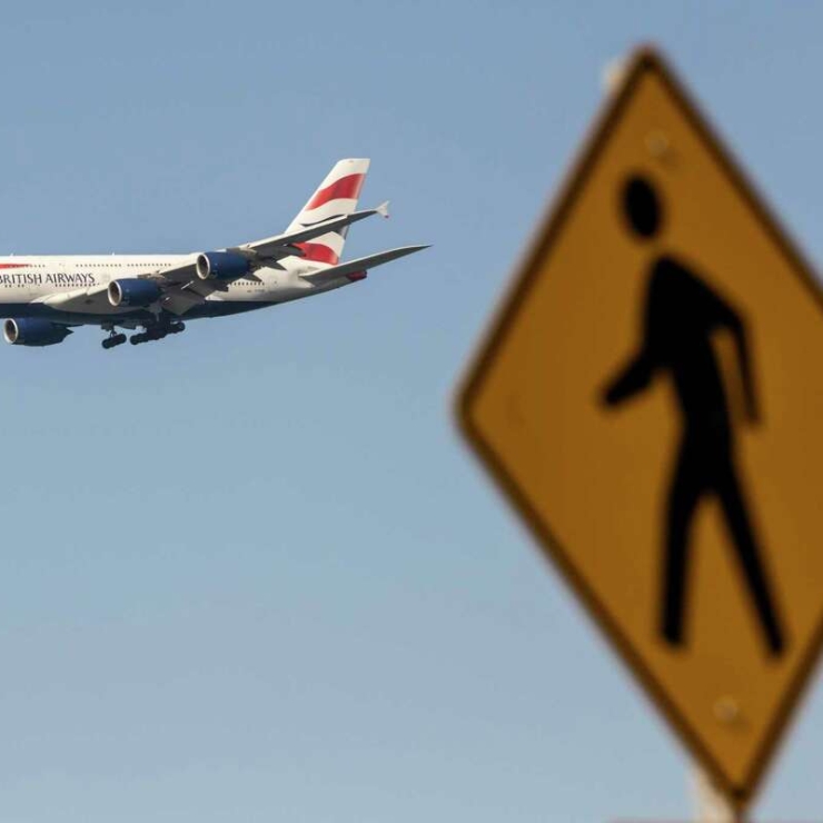 A British Airways plane approaches San Francisco International Airport in January. For those who want to reduce their emissions from flying, one tip is to take fewer trips that are longer in duration, as opposed to numerous short trips.