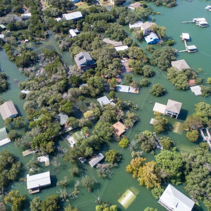 Homes in a Texas neighborhood are submerged in water.