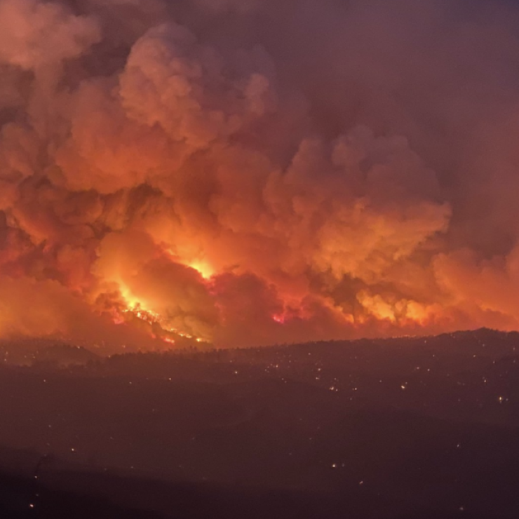 A wildfire rages on a distant hill in Arizona