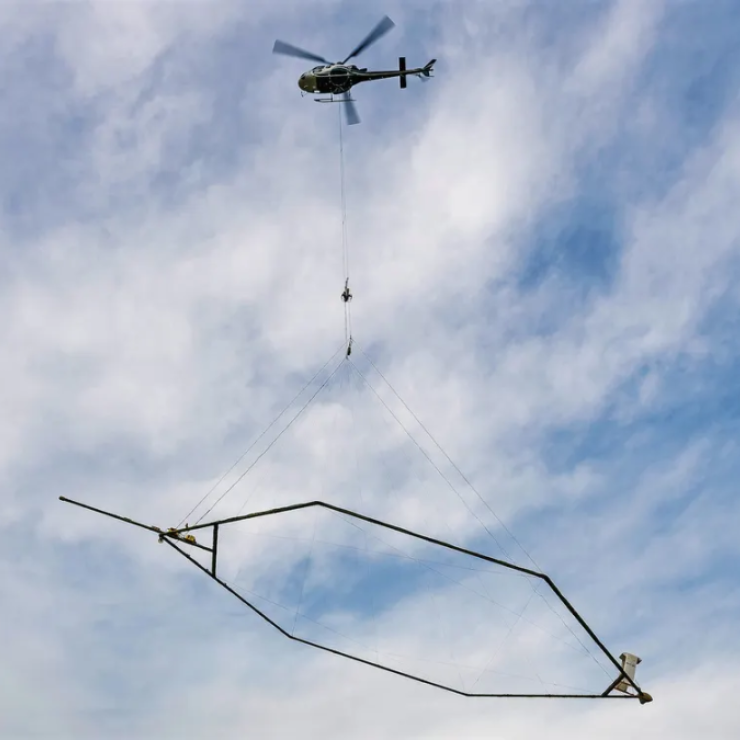 A giant electromagnet hanging from a helicopter.