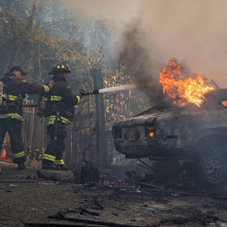 Firefighters put out a car on fire