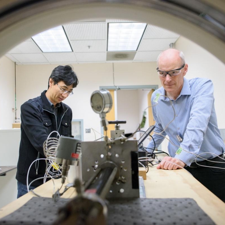 researchers working with CT scanner