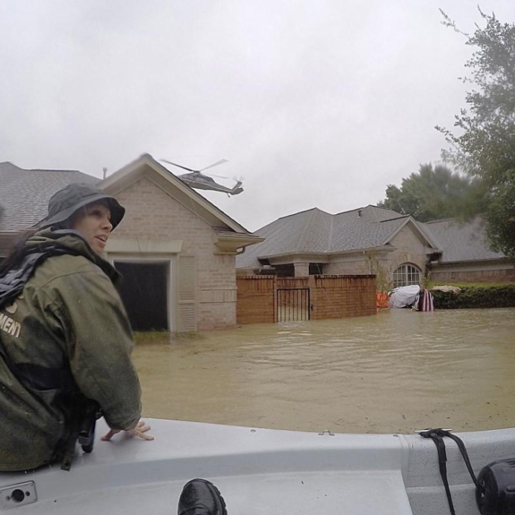 rescuer in boat in Houston flooding