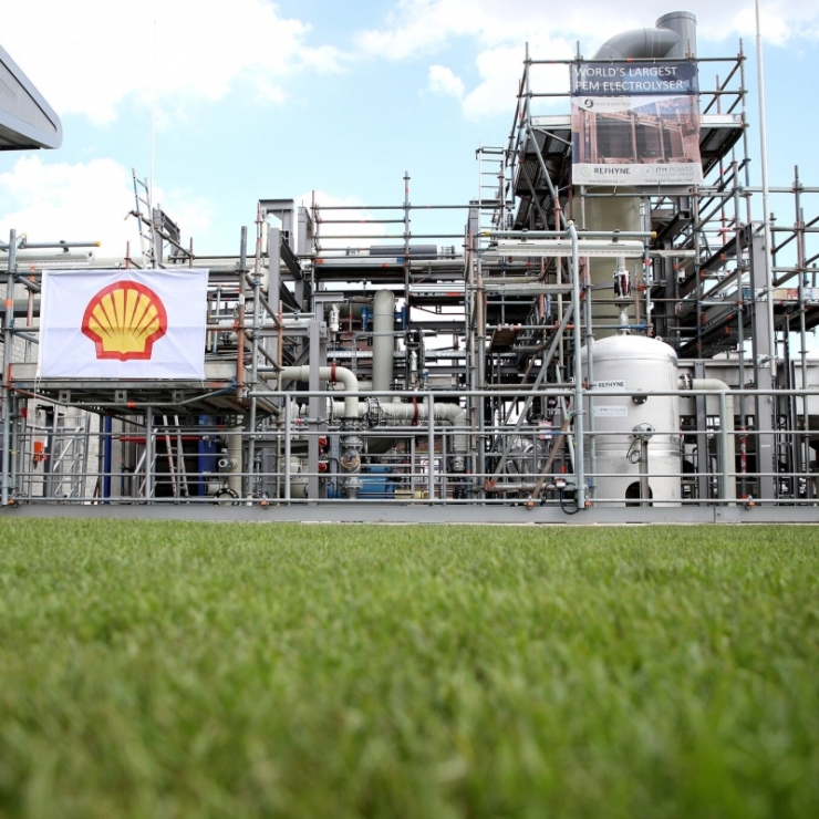 A German hydrogen production plant across a swath of green grass displays a Shell logo 