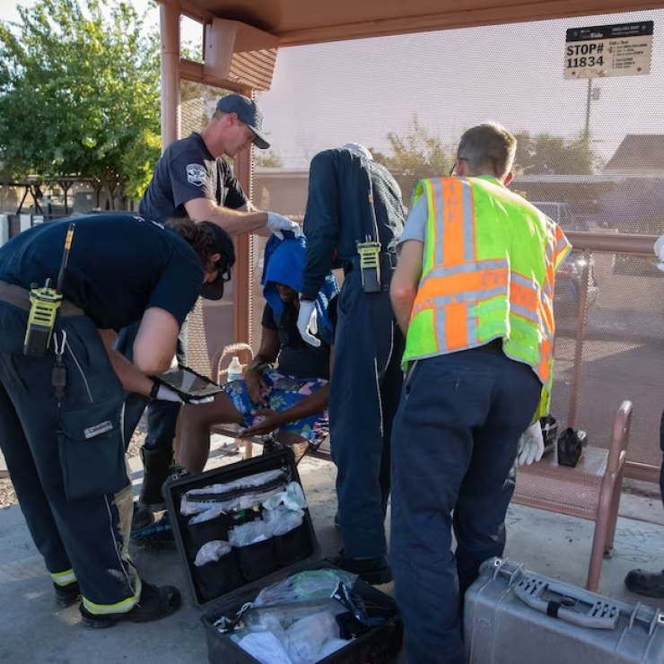 Firefighters assist a resident during a heat wave in Phoenix on July 20.