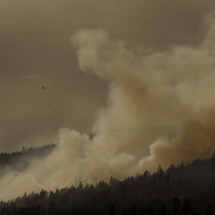 A helicopter bucketing a forest fire in British Columbia